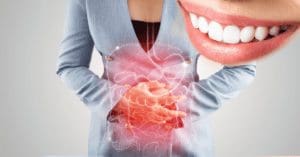 a person with irritable stomach, concept of Crohn's & Ulcerative Colitis: How it Can Affect Teeth