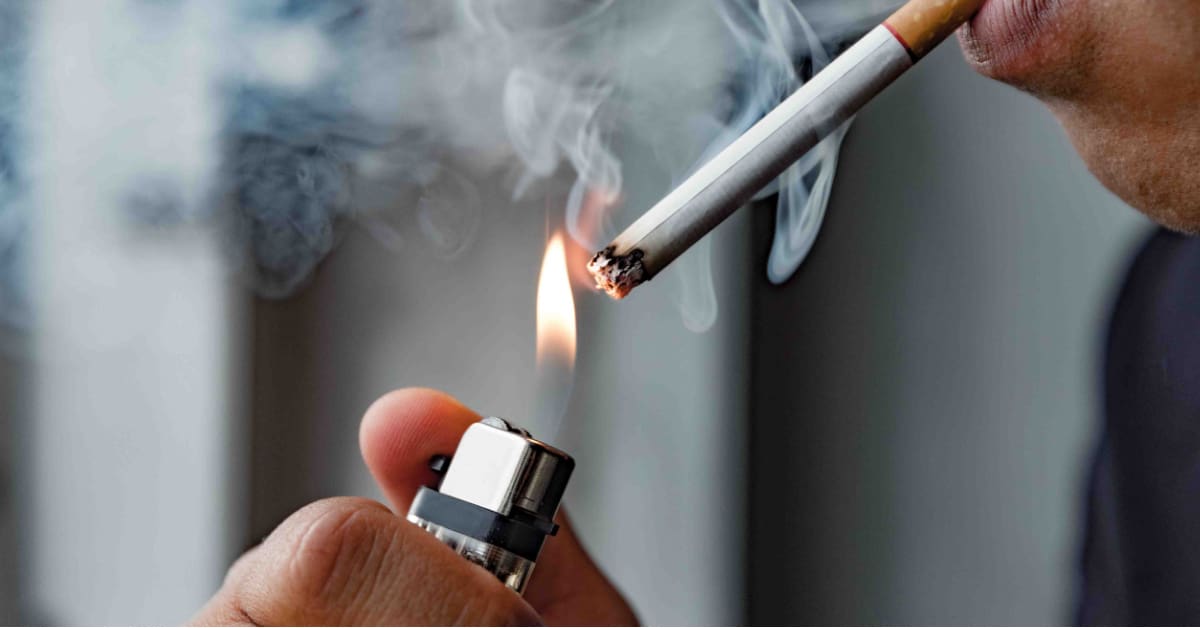 person with cigarette a lighter smoking