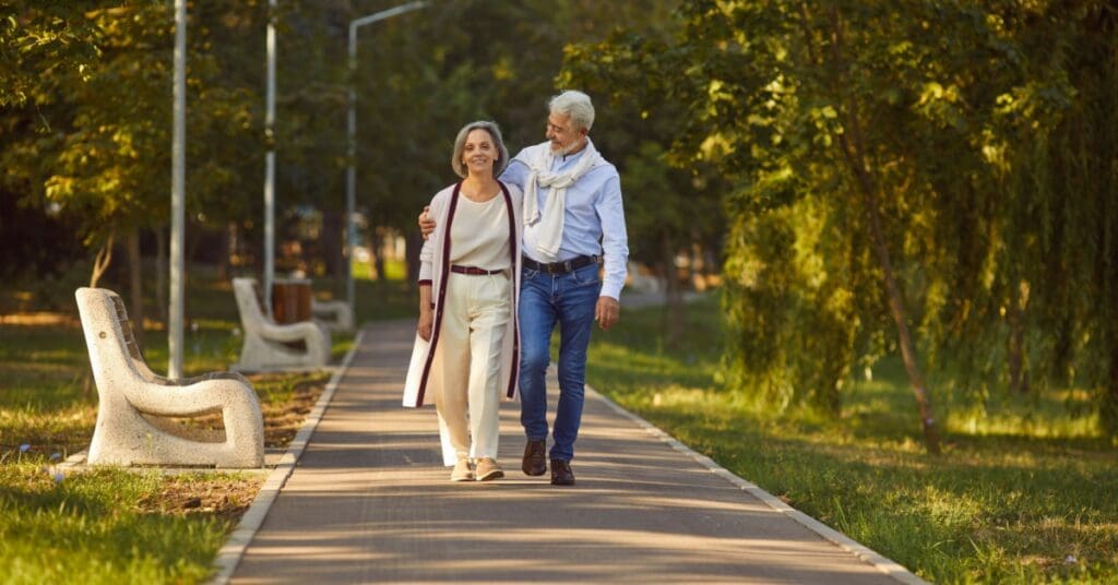 senior elderly couple walking in the park together