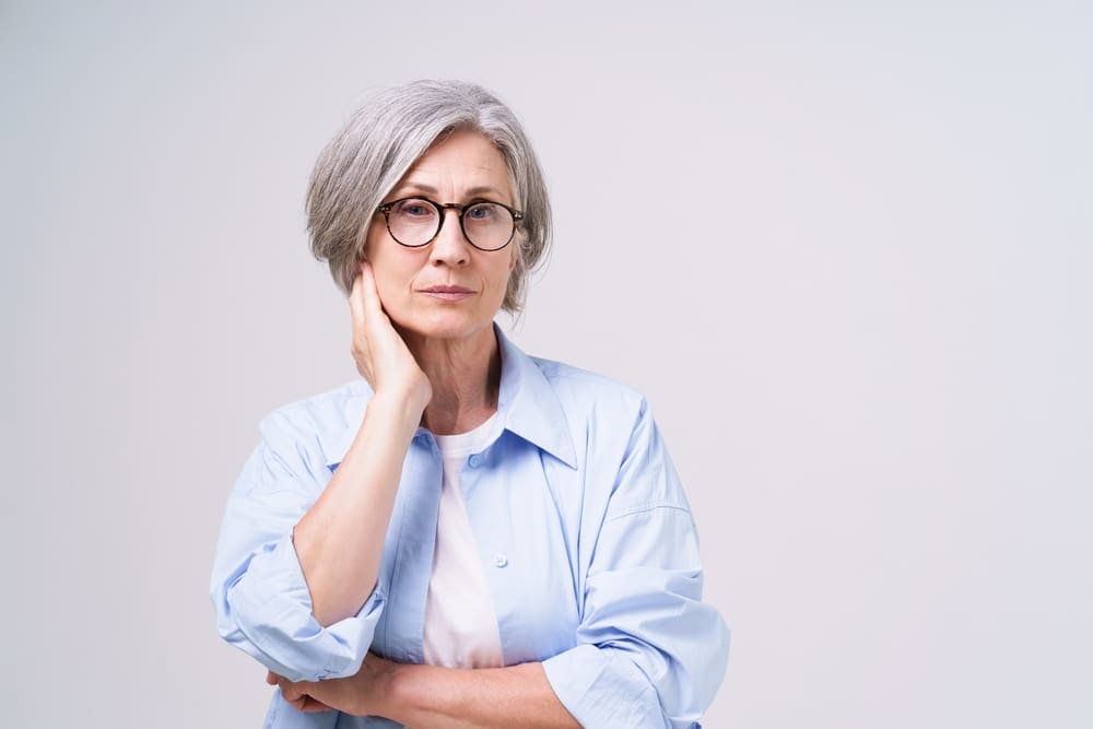 a woman holding the side of her face