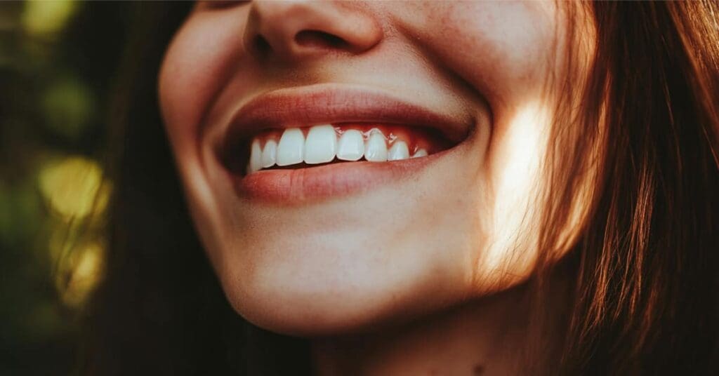 womens mouth smiling with beautiful teeth