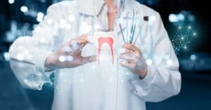 root canal specialist holding an image of a tooth with its roots