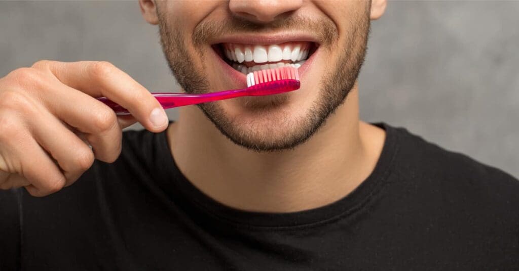 mans face brushing teeth, concept of dental health tips