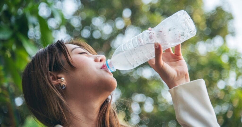 woman drinking water representing Which Foods Make Your Teeth Whiter