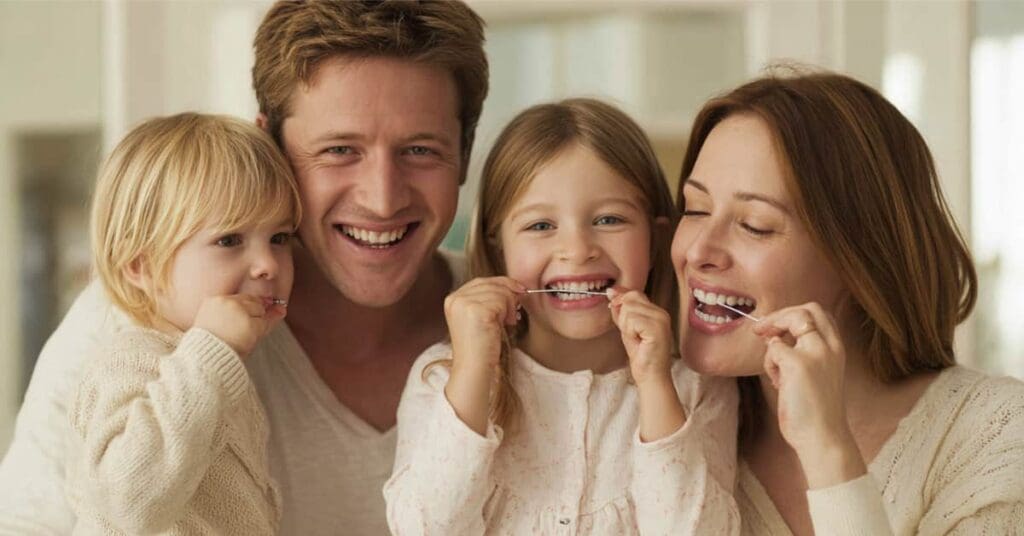 family flossing their teeth, concept of how to Make Flossing a Fun Family Activity